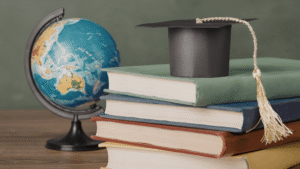 Some books with graduation cap and a world globe